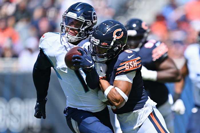Chicago Bears defensive back Kyler Gordon (6) tackles Tennessee Titans wide receiver Chris Moore (11) in the first quarter at Soldier Field.